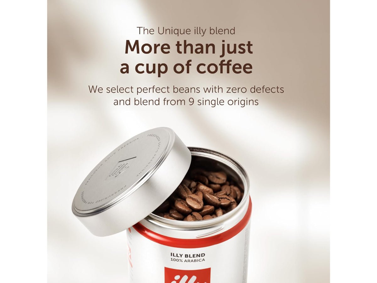illy whole coffee beans beside a compatible grinder